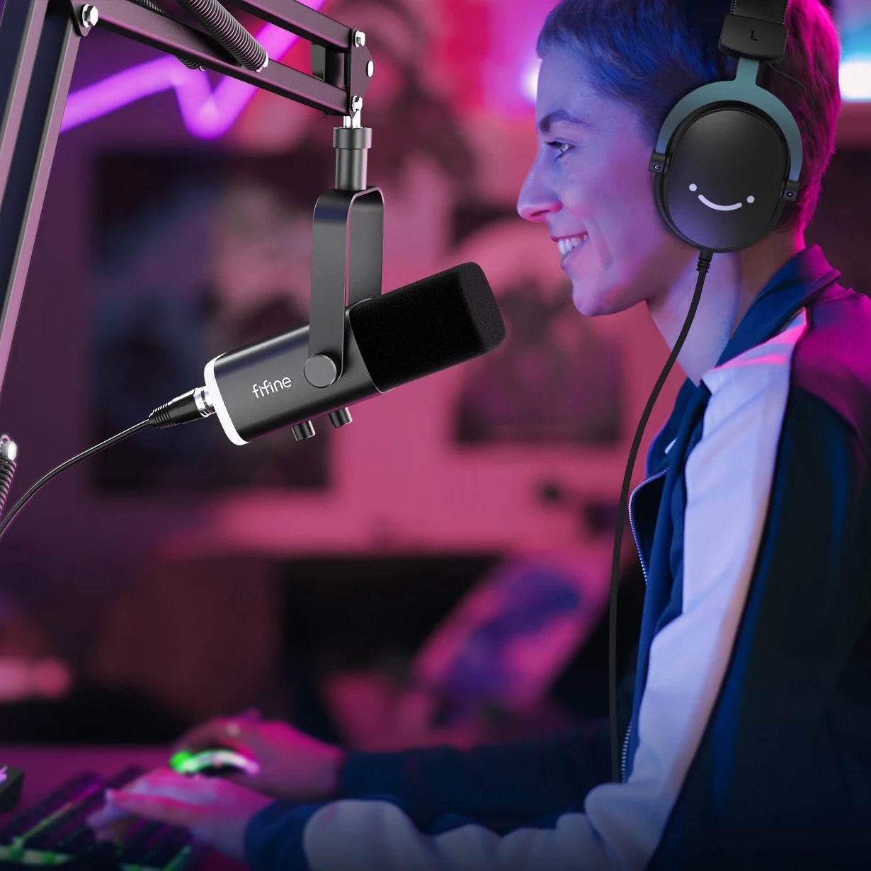 Person streaming or gaming with two monitors, a microphone, and headphones in a vibrant setting.